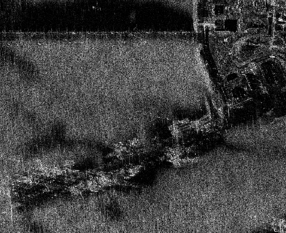 SAR image of Kawar Naval Base at 1 look; broad harbor context with higher speckle and lower clarity.