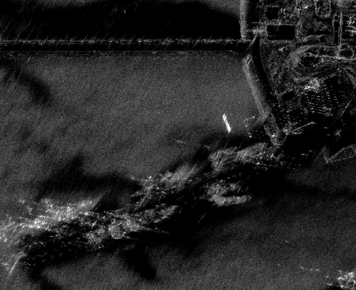SAR image of Kawar Naval Base at 4 looks; smoother water surfaces and finer structural detail along waterfront facilities.