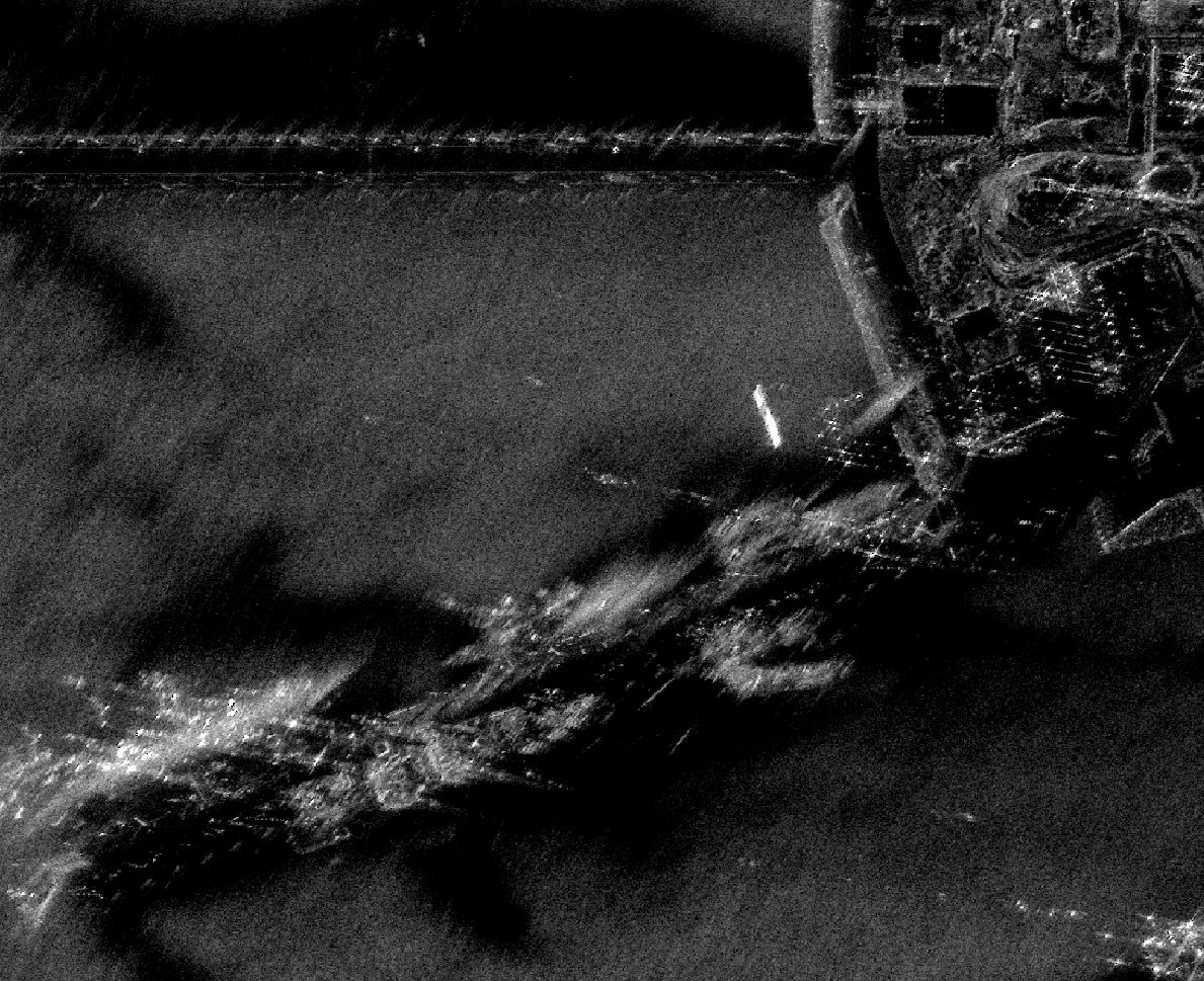 SAR image of Kawar Naval Base at 8 looks; lowest speckle and highest clarity of docks, breakwaters, and moored vessels.